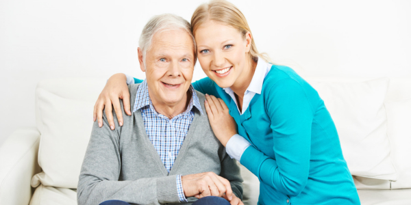 Caregiver and senior smiling
